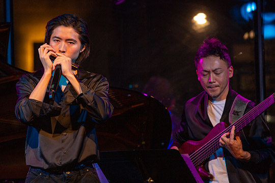 Harmonicist and band leader Cy Leo (left) and bassist Moto Fukushima performed on stage.