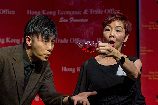 Louis Yan (left) interacts with a guest during his performance at the spring reception in Seattle.