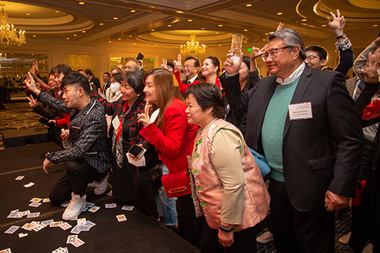 Louis Yan takes a group picture with guests at the spring reception in San Francisco.