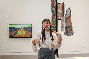 Designer Fiona Lau with her textile and clothing installation – a statement heralding greater sustainability by re-weaving fabric scraps or advertising billboards, while providing a new expression of colors, materials and techniques.